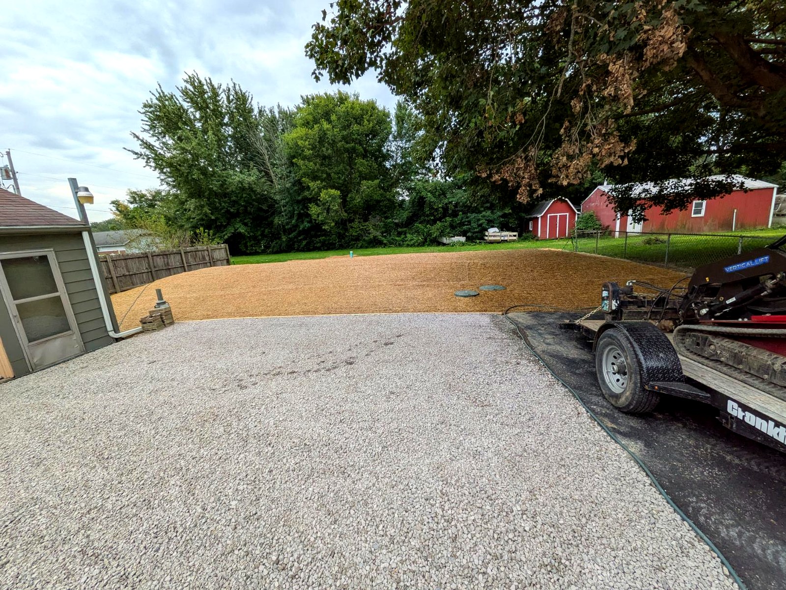 A freshly graded and seeded yard covered with straw