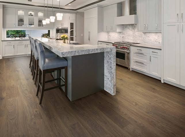 Dark wood-look floor in a white kitchen