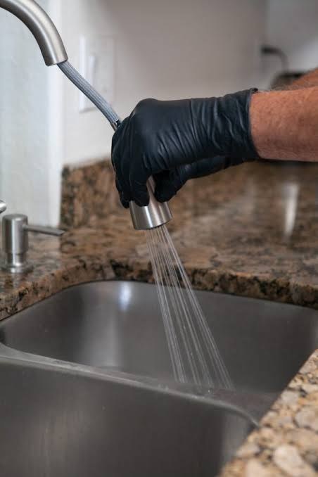 A pull-down kitchen faucet running into the sink